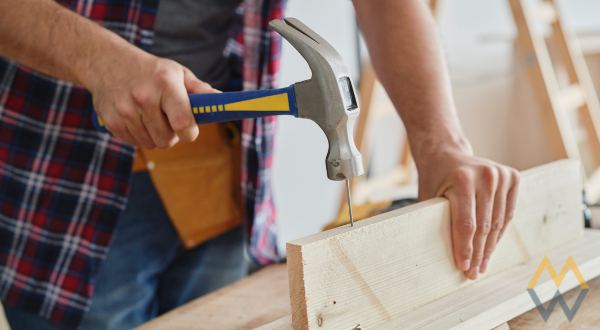 hammering a nail into a board